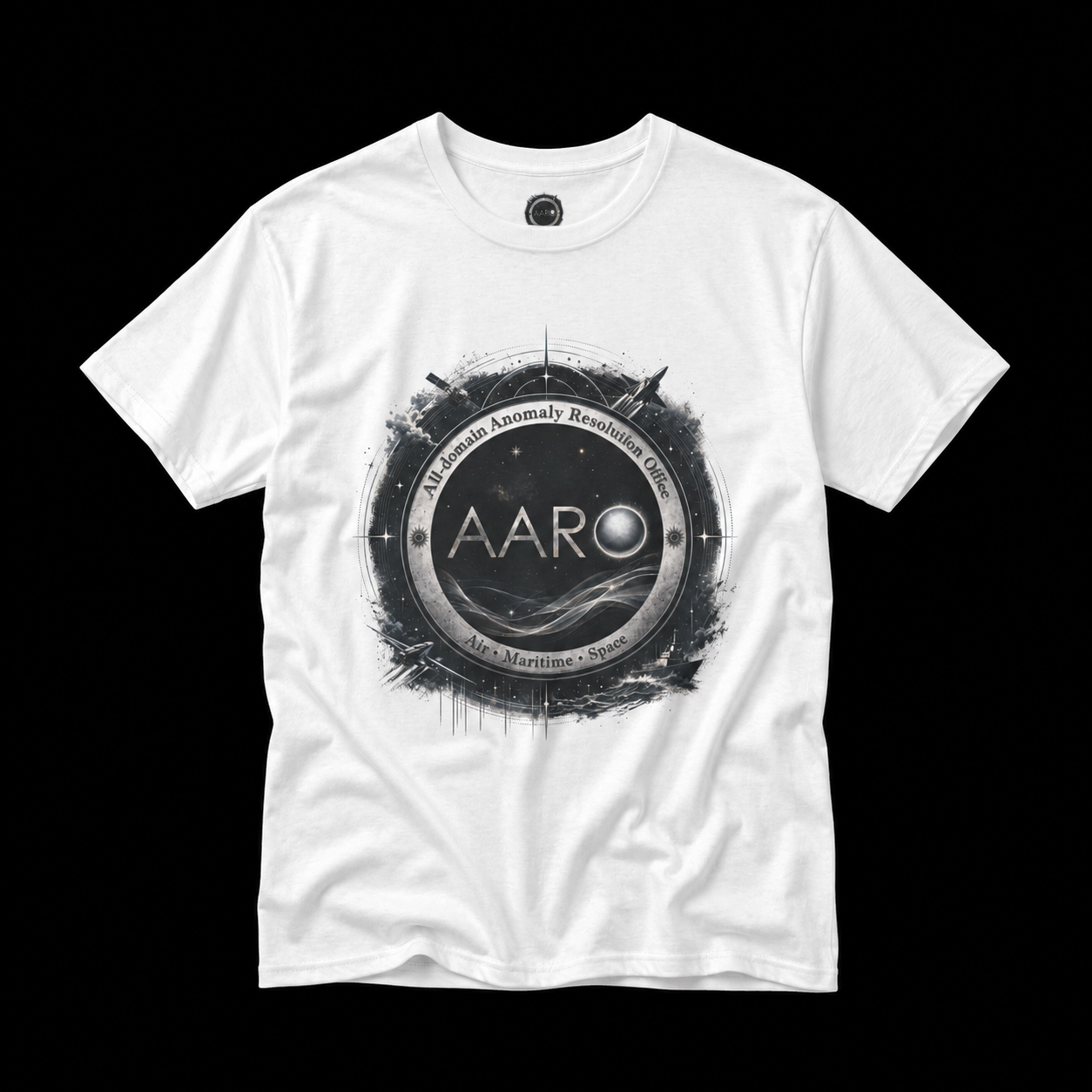 White AARO anomaly investigation T-shirt with black and silver space, aircraft, satellite, and maritime emblem graphic.