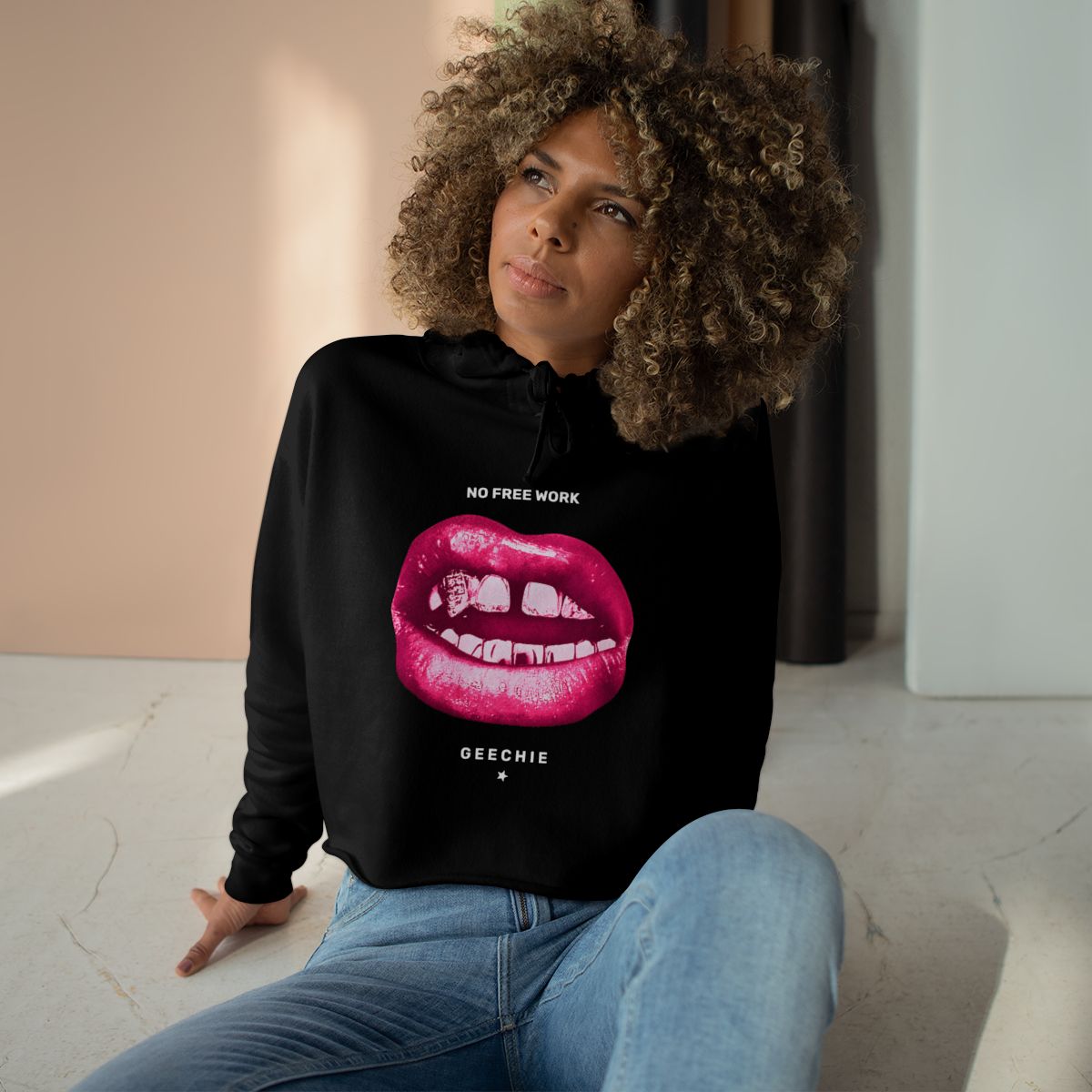 Model wearing the black GEECHIE No Free Work cropped hoodie